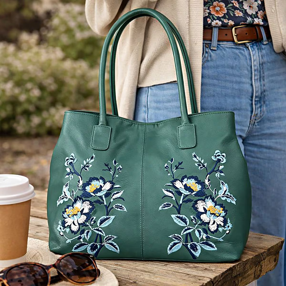 Turquoise leather tote bag with floral pattern