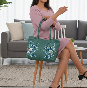 Turquoise leather tote bag with floral pattern