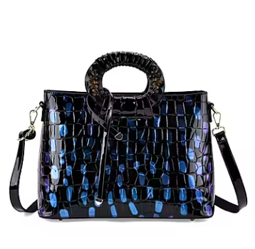 Blue round crossbody bag with dual handles and faux-crocodile texture.