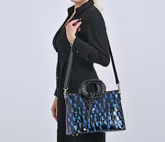 Blue round crossbody bag with dual handles and faux-crocodile texture.